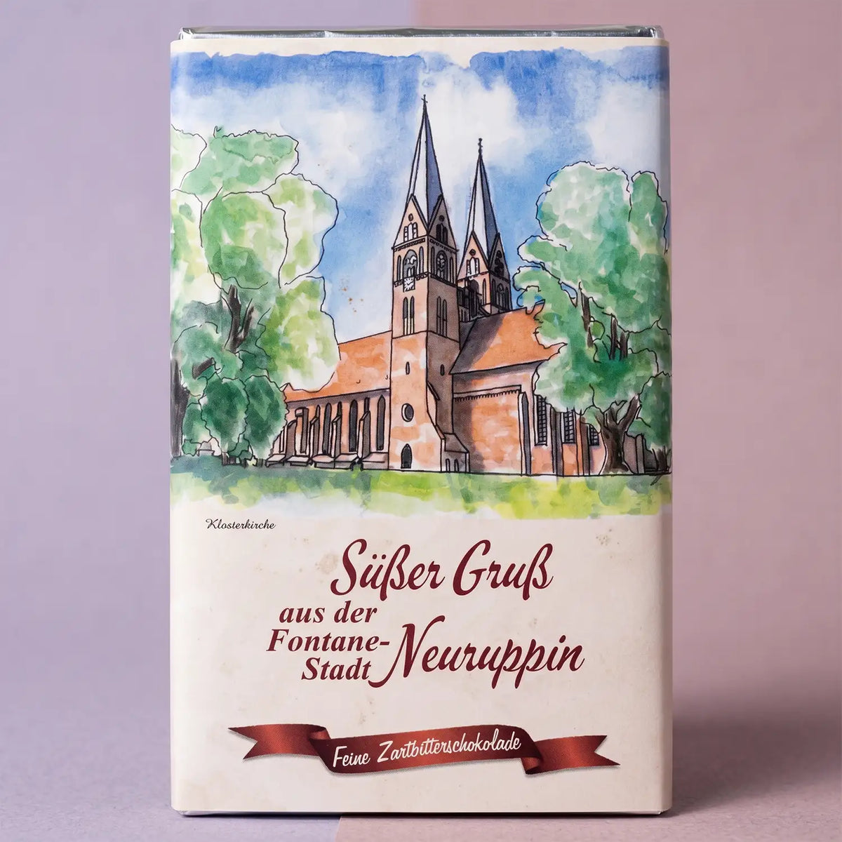 neuruppin-suesser-gruss-feine-zartbitterschokolade-125g-vorderseite-mit-pastell-hintergrund